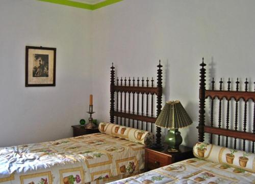a bedroom with two beds and a lamp in it at Quinta do Freixieiro in Cinfães