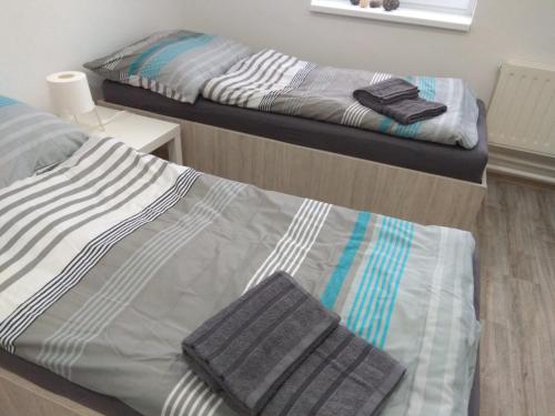 two beds in a room with two beds sidx sidx sidx at Apartmány U splavu in Veselí nad Moravou