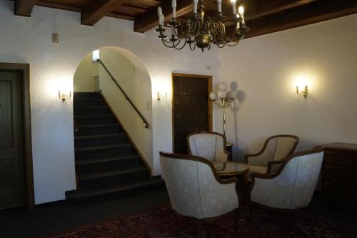 a dining room with a table and chairs and a staircase at Villa am Park in Bad Tölz