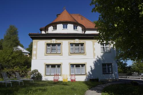 a large white building with a red roof at Villa am Park in Bad Tölz