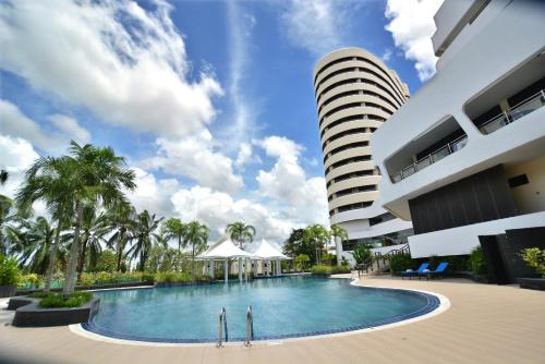 a swimming pool in front of a building at Rua Rasada Hotel - The Ideal Venue for Meetings & Events in Trang
