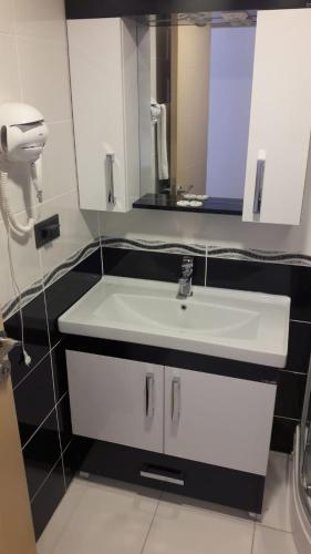 a bathroom with a white sink and a mirror at Özdemir Palas in Ankara