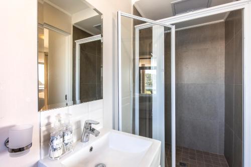 a bathroom with a sink and a shower at Stay at The Point - Spacious Sublime Stunner in Durban