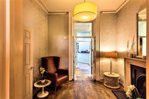 a hallway with a chair and a fireplace at The Sumner Hotel in London