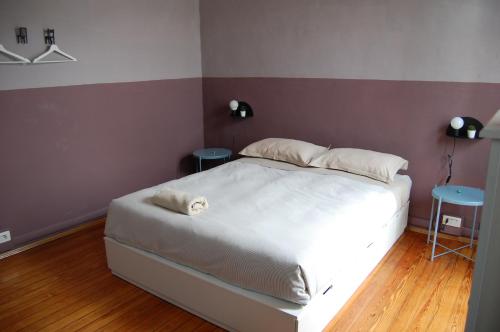 a bedroom with a white bed and two tables at La Boqueria in Bra