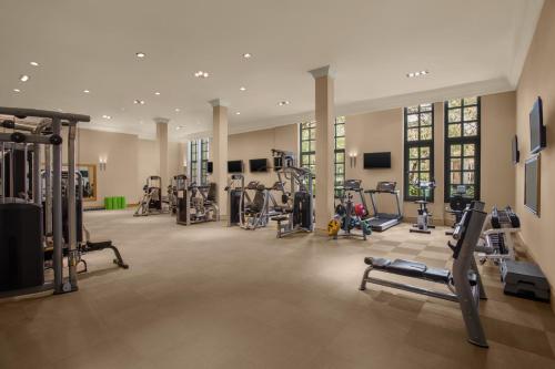 a gym with several treadmills and machines in a room at Paloma Foresta in Beldibi