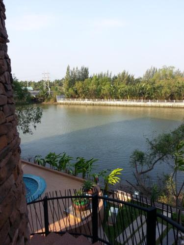a view of a body of water with a fence at Coco View Hotel in Samut Songkhram