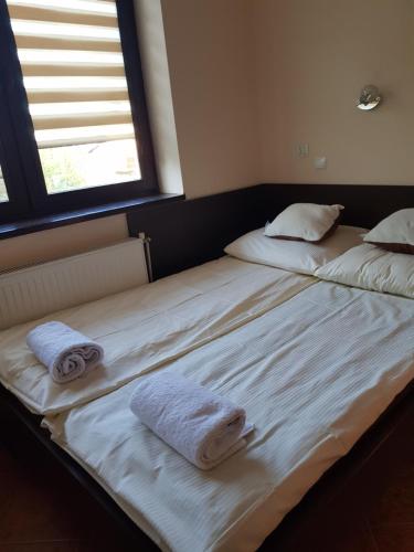 two beds in a room with towels on them at Pokoje Gościnne u Lidki in Władysławowo
