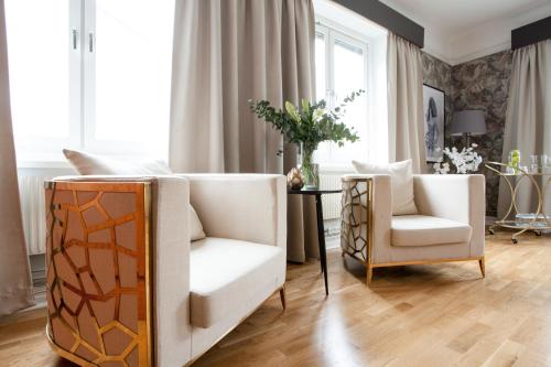 a living room with two chairs and a table at Centric Hotel in Norrköping