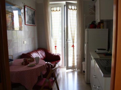 a kitchen with a table and a couch in a kitchen at La Cascata in Noci