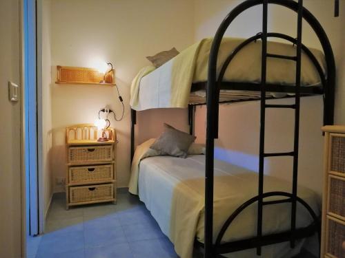 a bedroom with two bunk beds and a bed at Casa Vacanza NINA in Milazzo