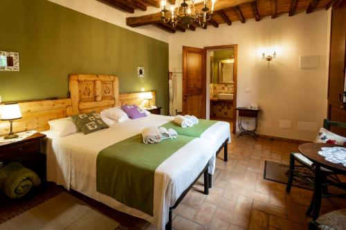 a bedroom with a large bed with towels on it at Villa Amadeo by PosarelliVillas in Montaione