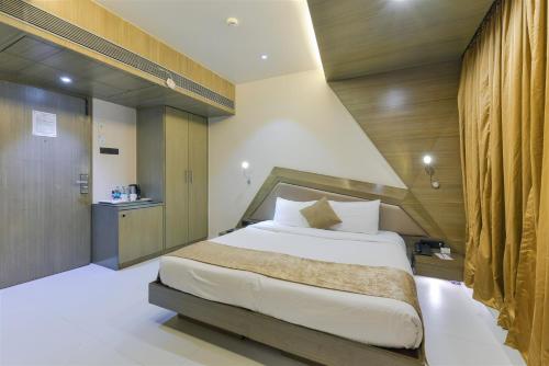 a bedroom with a large bed in a room at Dragonfly Hotel - The Art Hotel in Mumbai
