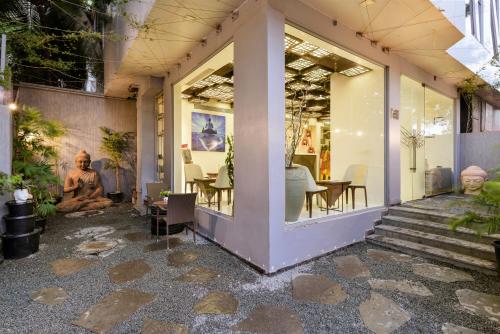 a store front with a table and chairs in a building at Dragonfly Hotel - The Art Hotel in Mumbai