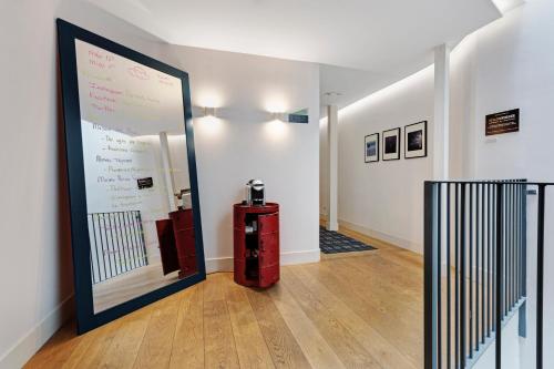 a hallway with a large poster on the wall at One Shot Prado in Madrid
