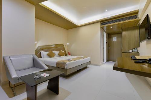 a hotel room with a bed and a desk at Dragonfly Hotel - The Art Hotel in Mumbai