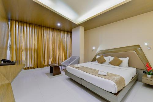 a hotel room with a bed and a desk at Dragonfly Hotel - The Art Hotel in Mumbai