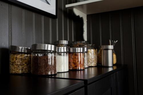 a shelf with many jars of food on it at Centric Hotel in Norrköping