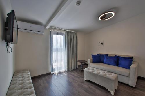 a living room with a couch and a tv at Kavala Hotel in Bursa
