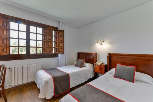 Cama o camas de una habitación en Hotel Santillana