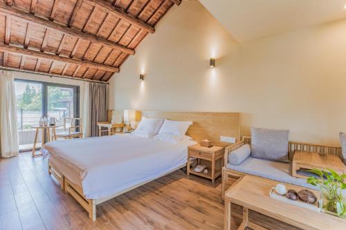 a bedroom with a large bed and a couch at Hangzhou Van Wind Inn in Hangzhou