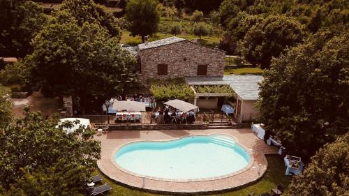 an overhead view of a swimming pool in front of a house at Ferme U San Martinu in Sisco