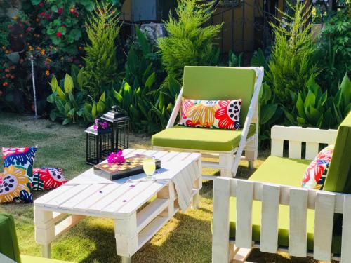 a patio with two chairs and a table and a bench at Nehir Dalyan Boutique Otel in Ortaca