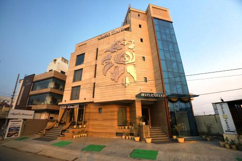 a building with a lion painted on the side of it at Maple Grand in Agra