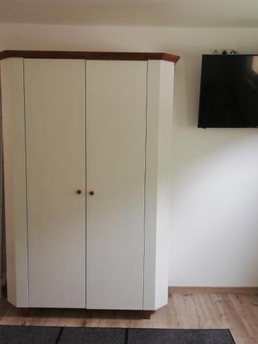 a white cabinet with a tv on a wall at Ferienhaus Am-moore in Steindorf am Ossiacher See