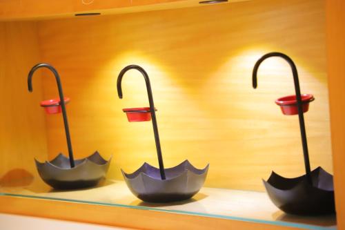three umbrellas on display in a display case at Maple Grand in Agra