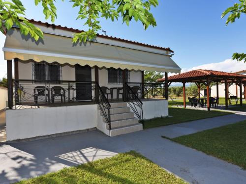 a house with a porch and stairs in a park at Mama's Twin Houses in Áyios Mámas