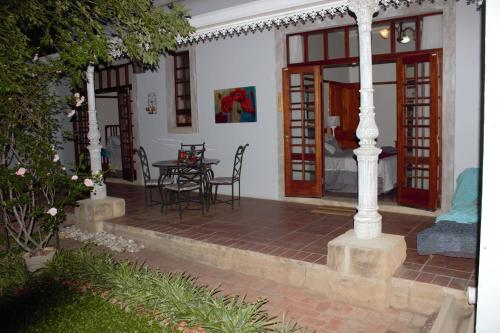 a patio with a table and chairs in a house at The Well guesthouse/Retreat in Kroonstad