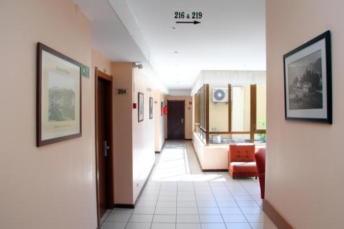 a hallway of a hospital with a chair and a room at Imperio Hotel in Peso da Régua