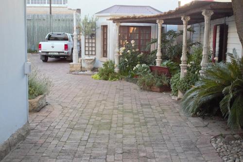 a brick driveway in front of a house at The Well guesthouse/Retreat in Kroonstad