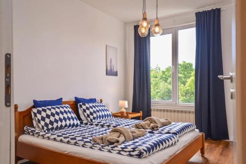 a bedroom with two beds with blue and white pillows at South Park, Vitosha View, 2-BDR, 2-BTHR Apartment in Sofia
