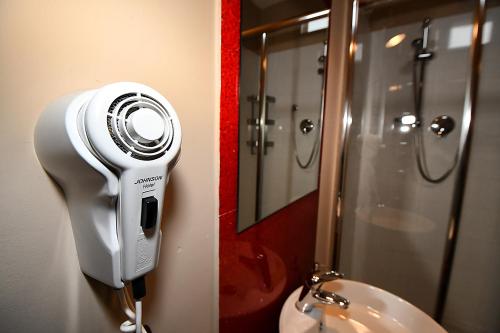 a soap dispenser on the wall of a bathroom at Antichi Quartieri in Piazza Armerina