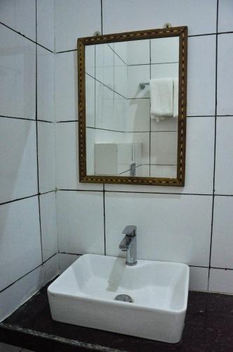 a white sink in a bathroom with a mirror at Hotel Vamdev Fort in Pushkar