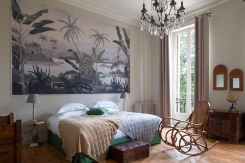 a bedroom with a bed with a large painting on the wall at Les Sources de Caudalie in Martillac
