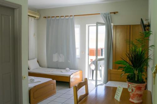 a hospital room with a bed and a balcony at Greta Apartments in Hersonissos