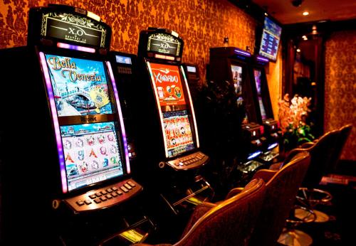 a row of video poker machines in a bar at Multi Grand Pharaon Hotel in Yerevan