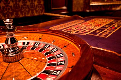 a roulette table in a casino with a roulette at Multi Grand Pharaon Hotel in Yerevan