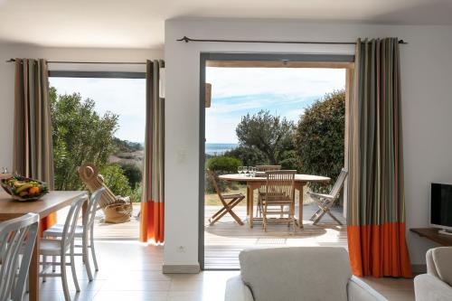 a living room with a sliding glass door leading to a patio at Domaine Santa Giulia Palace in Porto-Vecchio