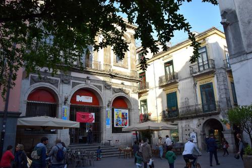 a group of people walking in front of a building at Le Suite del Duomo in Cava deʼ Tirreni
