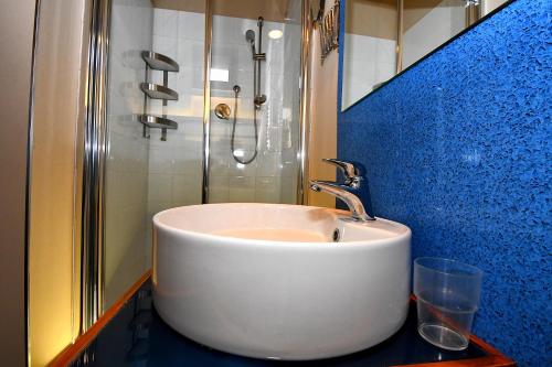 a bathroom with a white sink and a shower at Antichi Quartieri in Piazza Armerina