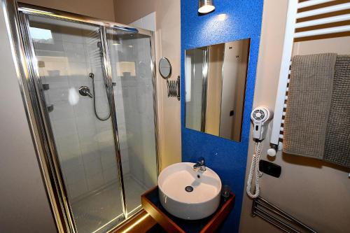 a bathroom with a shower and a white sink at Antichi Quartieri in Piazza Armerina