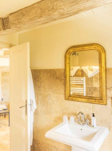 a bathroom with a sink and a mirror at Domaine de Saint-Géry - Teritoria in Lascabanes