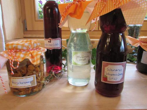 a table with three bottles of wine and a vase at Grillinghof in Kirchberg in Tirol