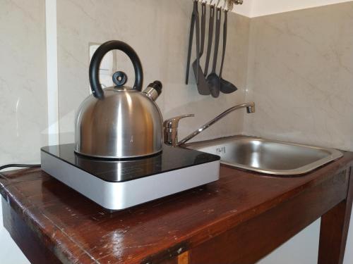 a tea kettle sitting on a counter next to a sink at Casa Patrikò in Perivólia