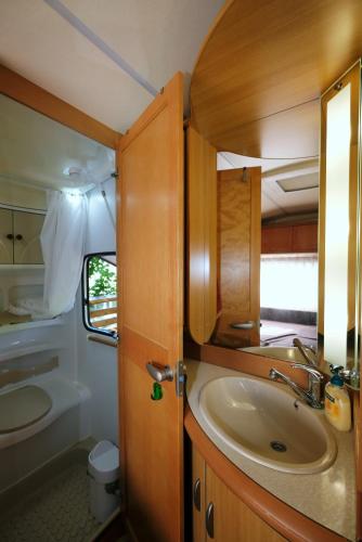 a bathroom with a sink and a mirror at Limnos Stone House in Kalliópi
