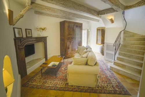 a living room with a couch and a fireplace at Domaine de Saint-Géry - Teritoria in Lascabanes